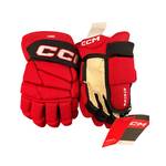A pair of red and black CCM HGTSC Jr. Canes hockey gloves.