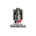 A hockey patch celebrating the 2026 Stanley Cup Champions, featuring a black and white graphic of the Stanley Cup trophy, the Carolina Hurricanes logo in red and black, and the text 'STANLEY CUP CHAMPIONS'.